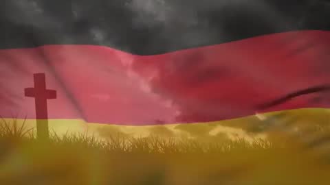 Wind Blowing German Flag Over Hillside with Cross