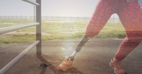 Disabled Woman with Prosthetic Leg Stretching Near Scenic Oceanside