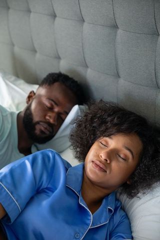 Peaceful Sleep for Diverse Couple in Comfortable Bedroom