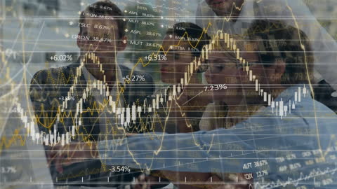 Business Team Analyzing Financial Graphs and Stock Market Trends