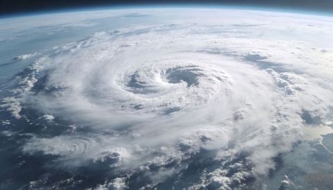 Spiraling hurricane eye revealing swirling cloud bands from orbital satellite view