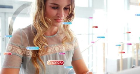 Young woman using tablet with augmented reality data overlays for marketing analysis