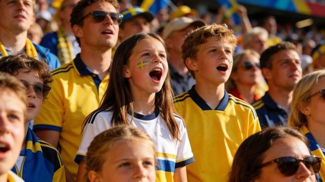 Young swedish fans cheering in stadium with painted flag faces and yellow jerseys