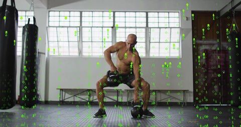Shirtless athlete lifting kettlebells in industrial boxing gym for strength training
