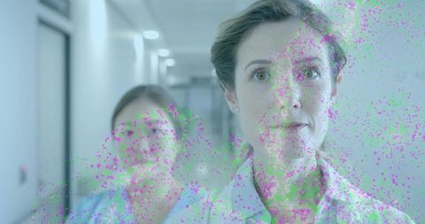 Nurse walking hospital corridor showing id badge with digital glitch overlay