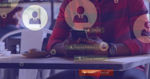 Man Engaged with Social Media on Smartphone at Cafe