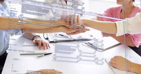 Business team stacking hands over digital data overlay showing collaborative tech teamwork