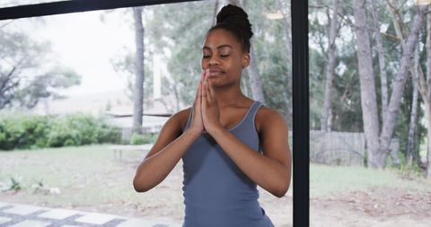 African American Woman Meditating Yoga Pose in Studio