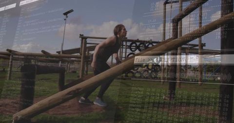 Determined athlete tackling outdoor obstacle course challenge