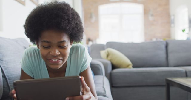 Young Girl Enjoying Digital Tablet on Couch - Download Free Stock Images Pikwizard.com