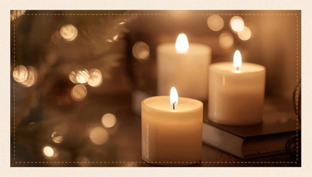 Ivory Pillar Candles Flickering on Cozy Tabletop with Bokeh Lights and Hardcover Book