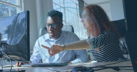 Diverse Colleagues Discussing Work in Modern Office Environment