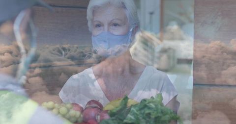 Elderly Woman Receiving Fresh Produce at Market with Cloud Overlay