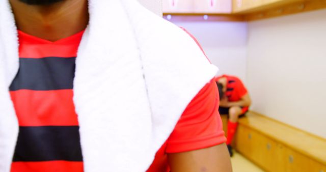 Soccer Player in Locker Room with Teammate in Background - Download Free Stock Images Pikwizard.com