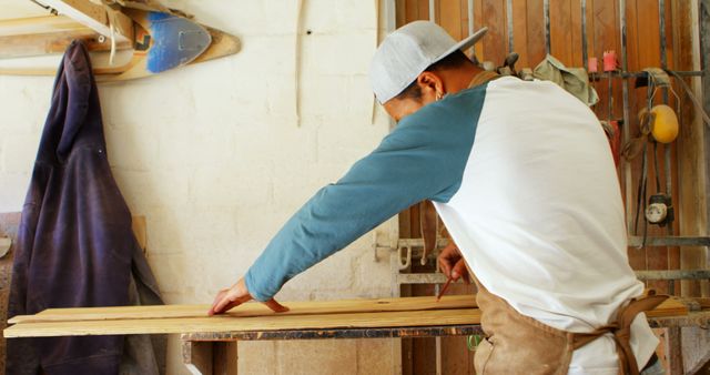 Craftsman Measuring Wood in Workshop Wearing Cap and Apron - Download Free Stock Images Pikwizard.com