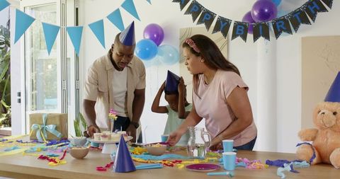 Family celebrating child's birthday with party decorations