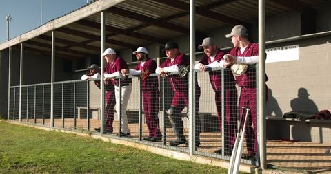 Baseball Team Enthusiastically Observing Game from Dugout