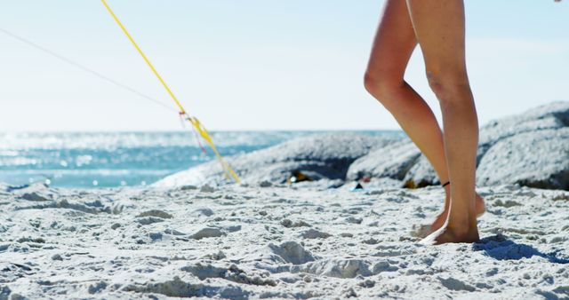 Person Walking on Sandy Beach by the Ocean - Download Free Stock Images Pikwizard.com