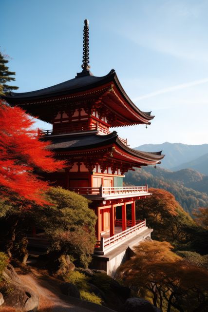 Stunning scene of a traditional Japanese pagoda surrounded by vibrant autumn foliage with mountains in the background. Perfect for travel brochures, cultural presentations, educational materials on Japanese heritage, desktop wallpapers, and decorative posters.