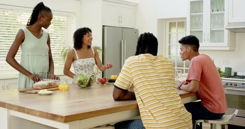 Friends Preparing Healthy Meal Together in Modern Kitchen