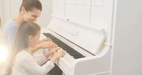 Mother and daughter piano lesson at home for bonding and music practice