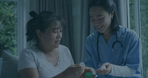 Nurse Assisting Patient with Medication at Home