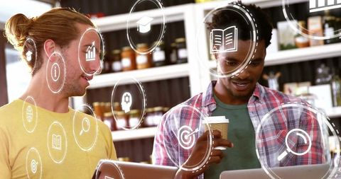 Tech-savvy coworkers collaborating at coffee counter with digital icons