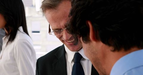 Business Professionals Strategizing Project in Modern Office