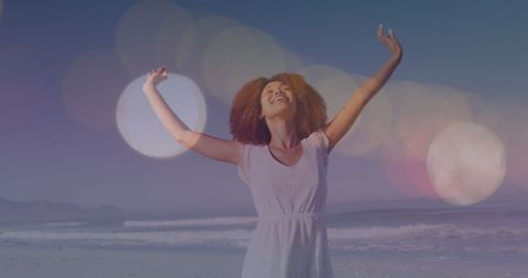 Joyful Woman with Arms Raised Enjoying Beach at Sunset