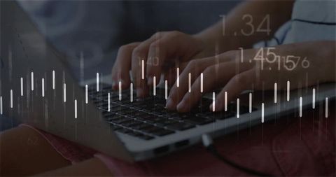 Typing hands on laptop with financial candlestick overlay for remote work and data analysis