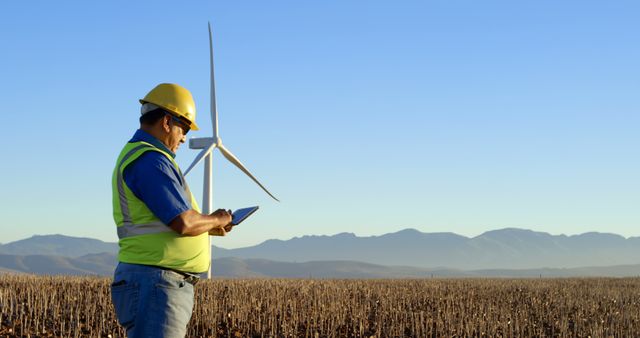 Engineer Inspecting Wind Turbine Using Tablet in Rural Field - Download Free Stock Images Pikwizard.com
