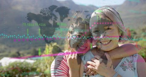 Mother daughter hugging on sunny hillside with global finance data overlay for fintech