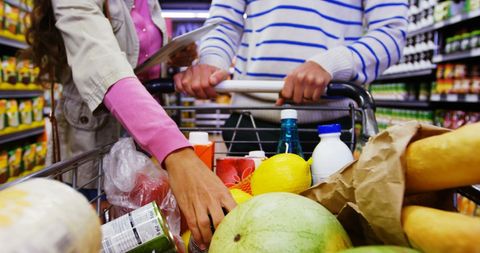 Couple Shopping with Digital Tablet in Grocery Aisle