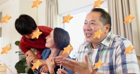 Multigenerational family sharing warm meal and lively conversation around dining table