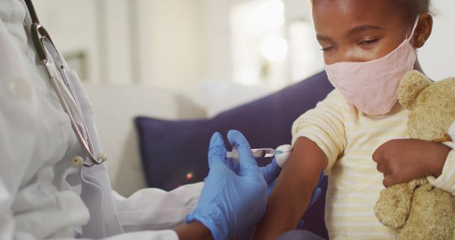 Child receiving vaccination shot in arm from healthcare professional. Perfect for healthcare campaigns, medical articles, pediatric care materials, and promoting vaccinations in children.