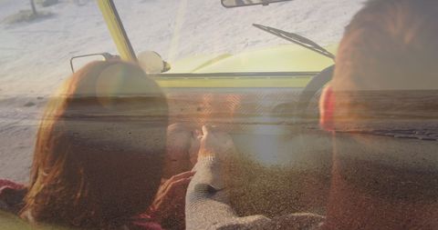 Couple relaxing in beach car overlooking serene seascape