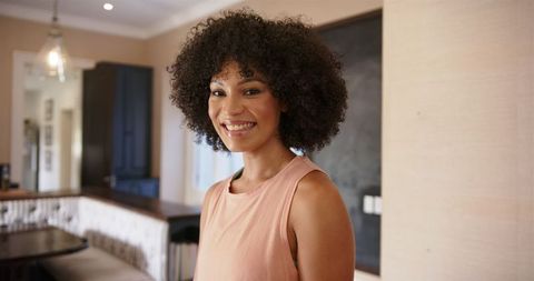 Smiling Woman Standing in Stylish Modern Interior
