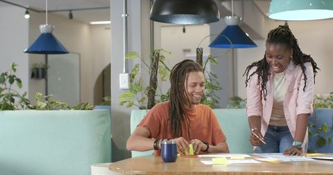 African american coworkers collaborating in modern coworking space with sticky notes