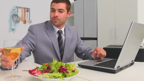 Businessman Enjoying Healthy Lunch While Working on Laptop