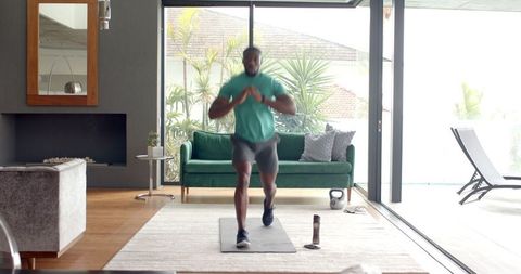 African American Man Engaging in Home Kettlebell Workout