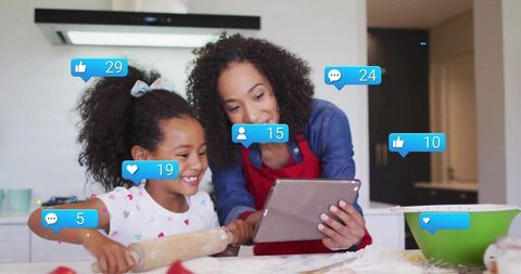 Mother and daughter baking together in a digitally connected kitchen