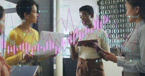 Diverse women discussing business growth with digital graphics