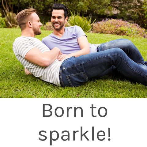 Happy gay couple relaxing on grass in park