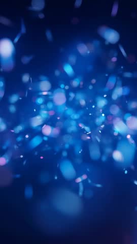 Glowing blue particles drifting through navy bokeh field vertical video