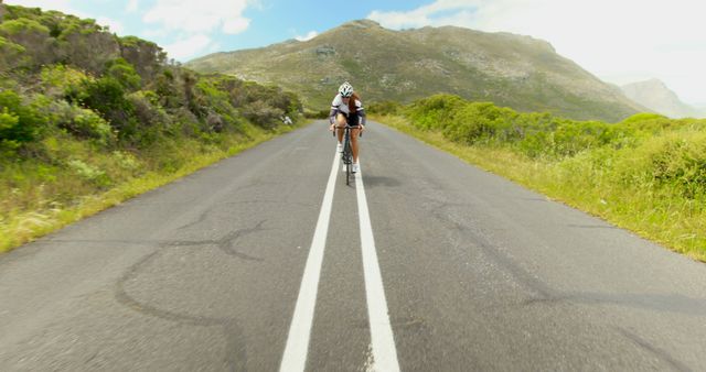 Cyclist Riding on Empty Mountain Road with Scenic View - Download Free Stock Images Pikwizard.com