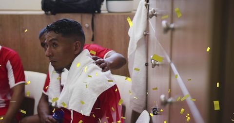 Football players celebrating victory in locker room