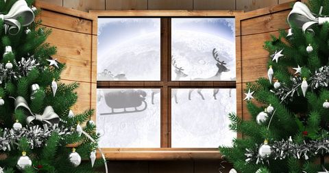 Santa sleigh silhouette seen through festive window