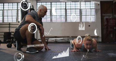 Trainer coaching female client doing push-ups in gym with fitness data overlay