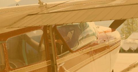 Pilot checking tablet in vintage single-engine aircraft