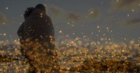 Romantic Couple Hugging on Beach at Sunset with Golden Bokeh